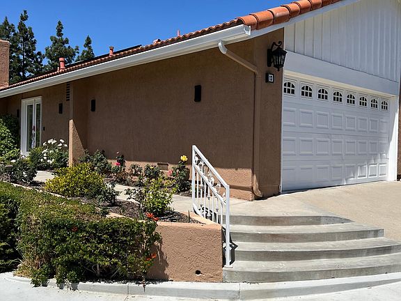 Corner lot home with walkway to custom double front doors