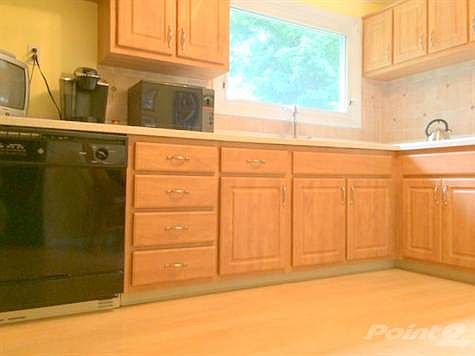 Updated kitchen with new Pergo flooring, solid surface countertops and tile back splash.