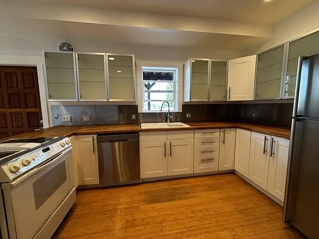 Large kitchen with a dishwasher and a view from the sink. Lots of cabinet space.