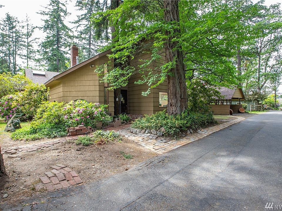 Beautiful rhododendrons and mature trees surrounded the house.