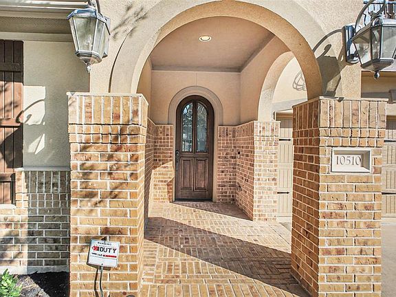 Welcoming covered front porch and attractive dark wood entry door