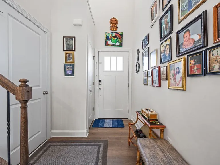 Front door entrance with door to garage on left facing