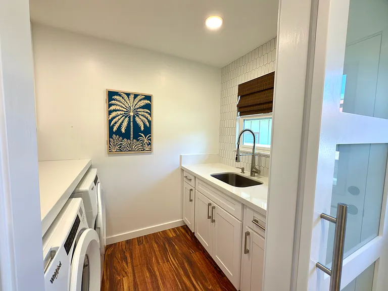 Laundry room with sliding barn door (washer, dryer, sink, storage)