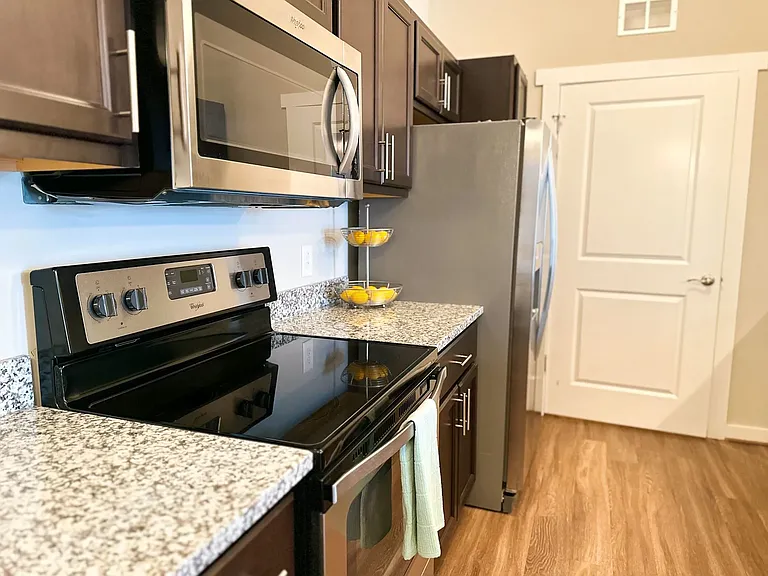 The kitchen feature stainless steel appliances including, microwave, range, refrigerator, freezer, and dishwasher.