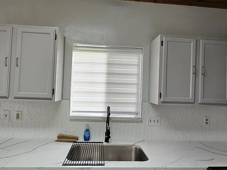 5. Cabinets-Kitchen with granite counters, refinished cabinets, new vanity, fixtures, and gas cooking