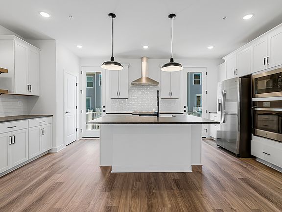 Kitchen with white cabinets pendant lights