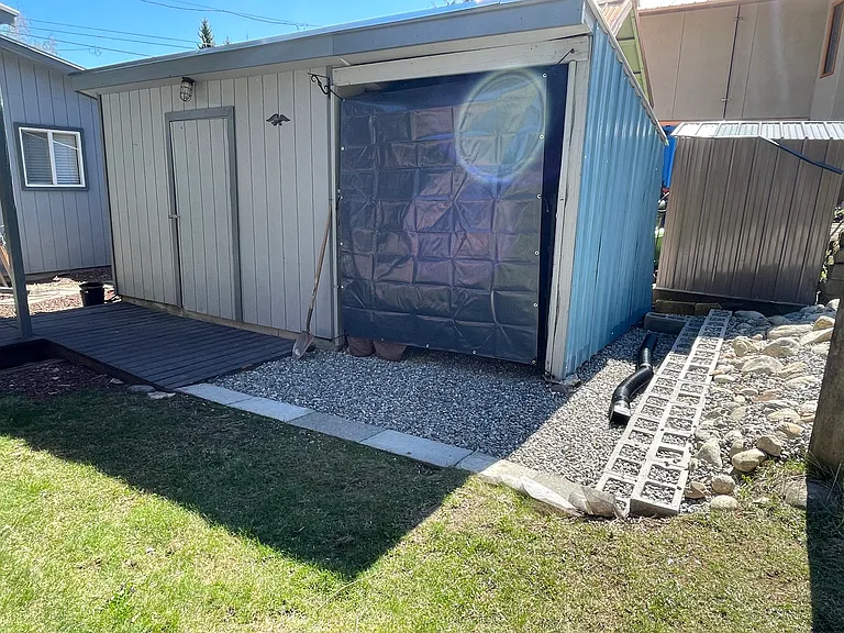 Shed with door on left is for owner use only, shed area on the right with tarp covering for tenant use