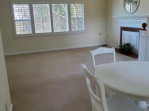 Looking out from next to the kitchen doorway, past the dining table into the living room.