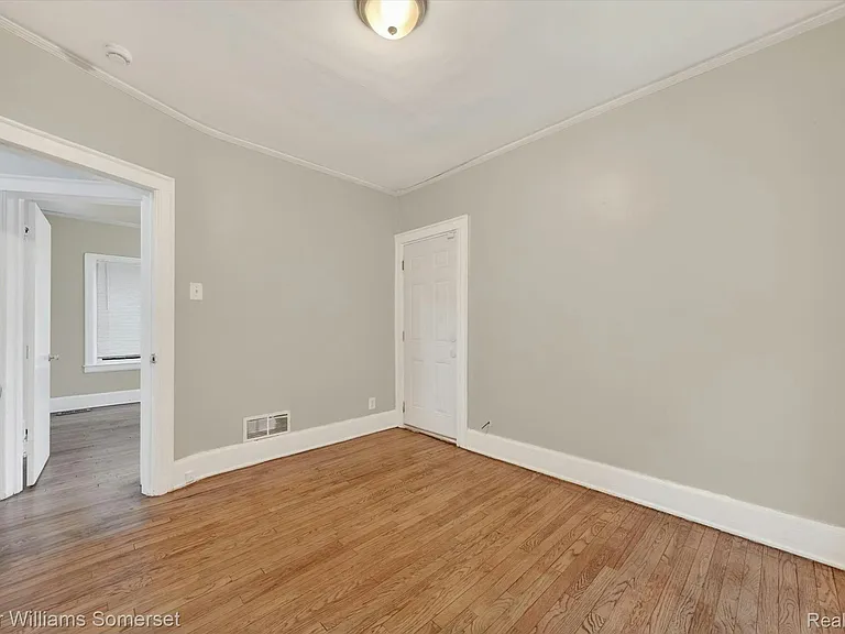 Bedroom #3, with closed off exterior door. Back right corner of building.