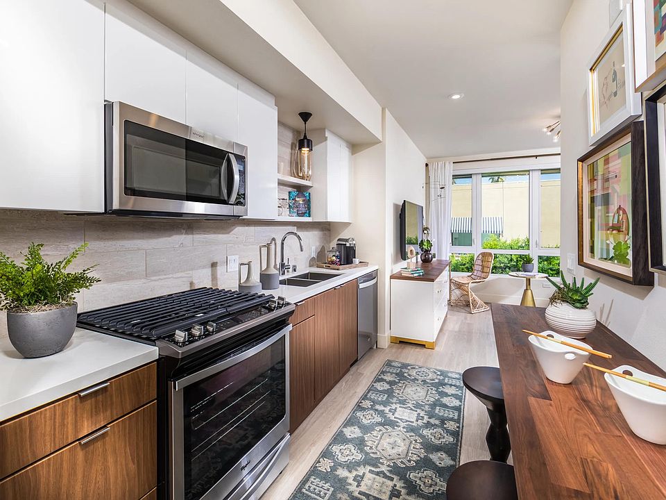 Gourmet kitchen with premium quartz surfaces and sleek appliances for inspired cooking.