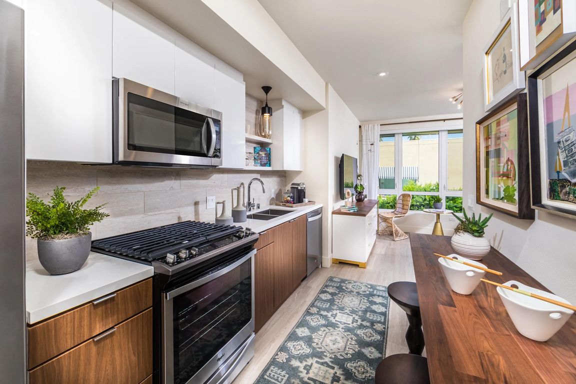 Gourmet kitchen with premium quartz surfaces and sleek appliances for inspired cooking.