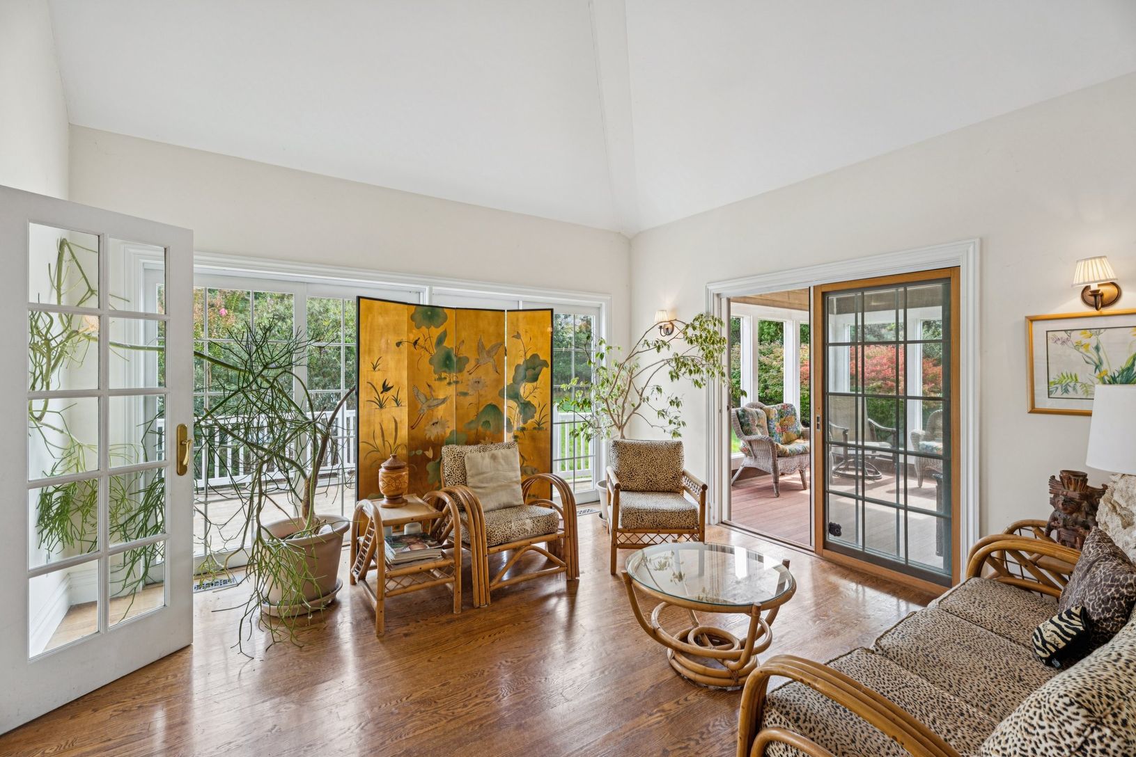 An inviting living area adorned with rich wood-finished floors and a breathtaking cathedral ceiling.