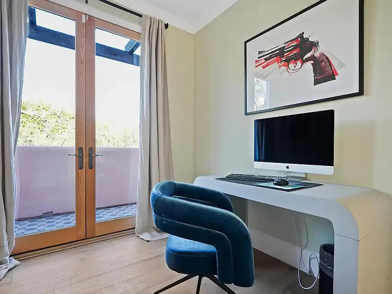 Guest bedroom with a dedicated workspace for productivity.