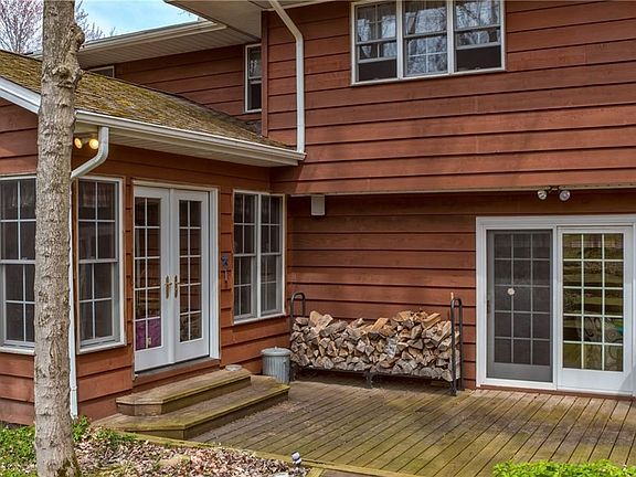 Rear view, french doors open to kitchen addition, sliding glass doors open to family room.