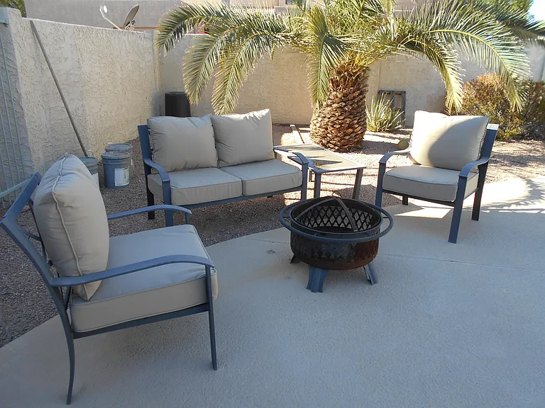 Pool sitting Area with Firepit. Also table & Chairs with a Weber Grill