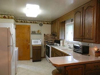 Updated kitchen cabinets with gas range & refrigerator