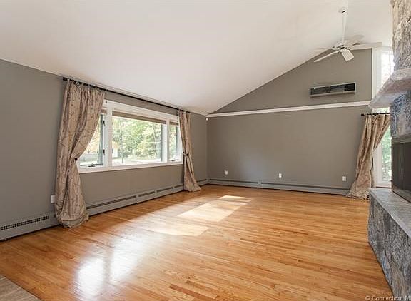 Vaulted ceilings, recently refinished hardwood and beautiful stone fireplace in living room.