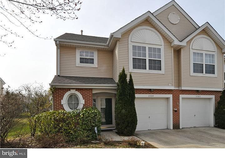 Outside view of end unit in a quiet neighborhood.