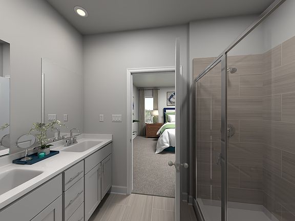 The primary bathroom offers dual vanity sinks and a walk-in shower.