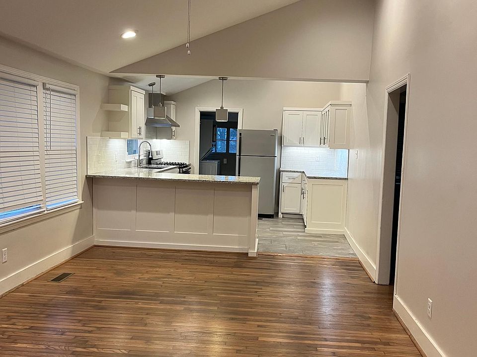 Open living area to remodeled kitchen. Includes new floors, granite, cabinets, lighting, and more.