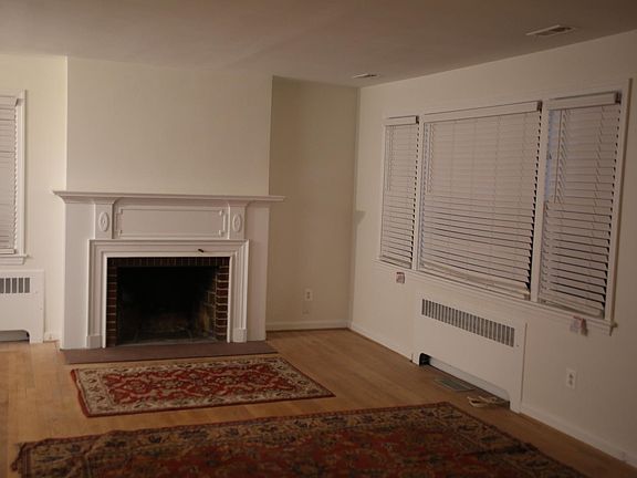 Fire place and bay window in LR adjacent open space to dining room on the left