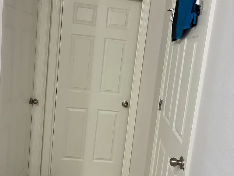 Master bath room with walk in closet directly in front and the bathroom enclosed to the left and another smaller closet to the right.