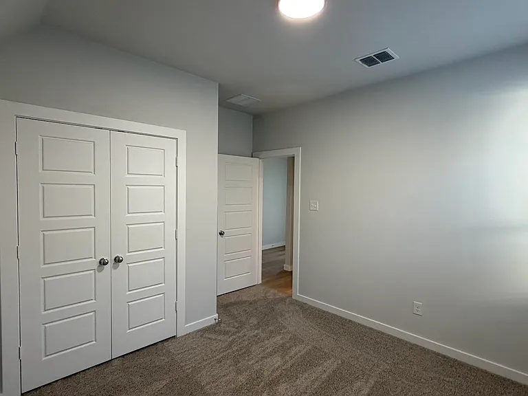 Generously sized secondary bedroom on the first floor offers a perfect guest retreat or a private, quiet space for a second home office