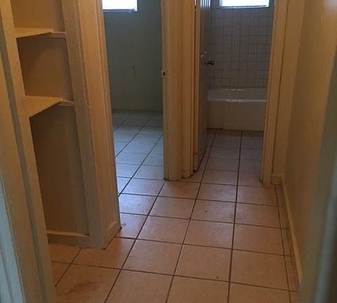 hallway with built-in shelves