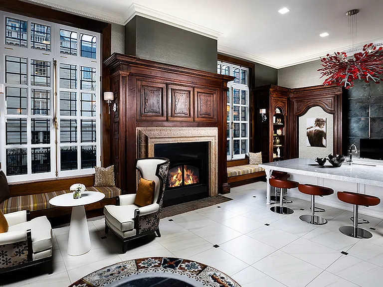 Cozy up in the Biblioteca, a resident lounge complete with fireplaces and historic millwork