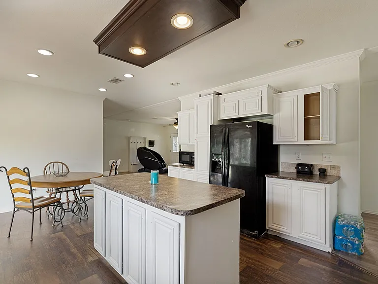 Kitchen features a large island with ample prep space, generous cabinetry, and room for casual dining nearby.
