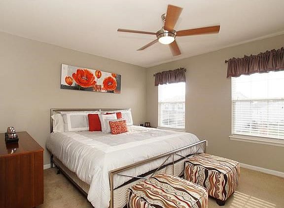 Master bedroom with upgraded ceiling fan, private bath and a walk in closet