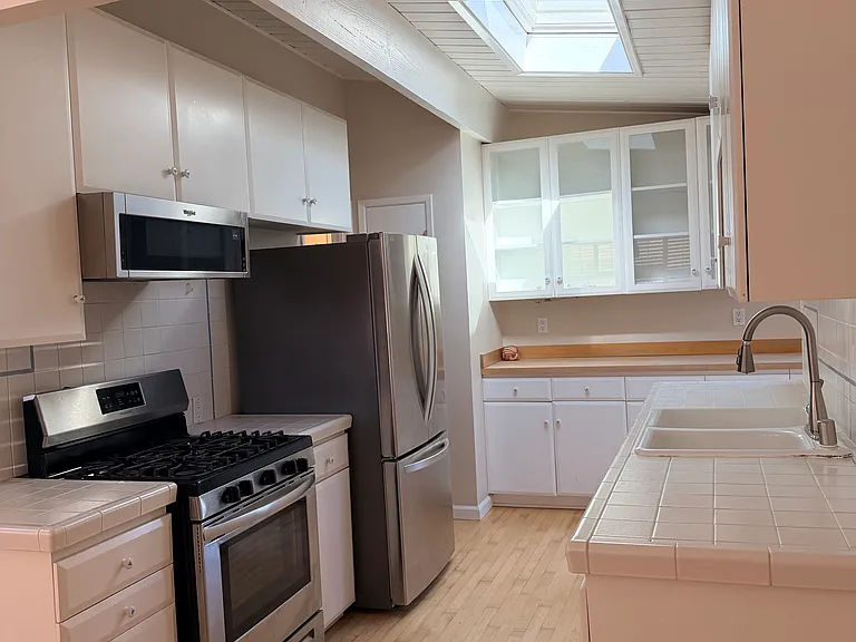 Kitchen with skylight and stainless steel appliances