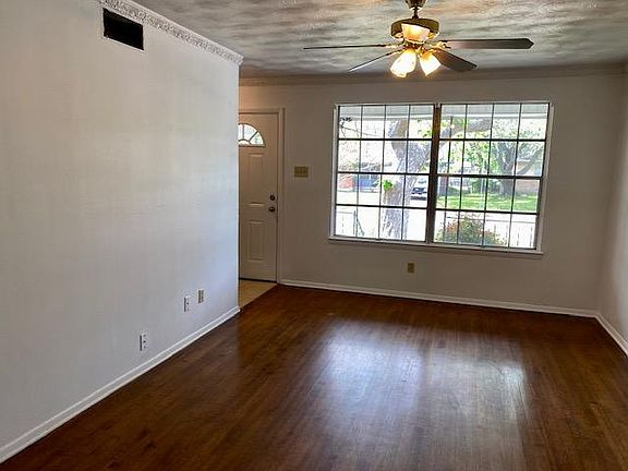 Living room with hardwood floors and original crown molding.