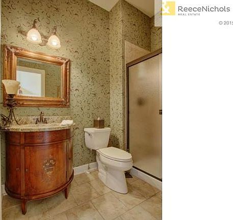 Custom Ethan Allen vanity graces the main floor bathroom.