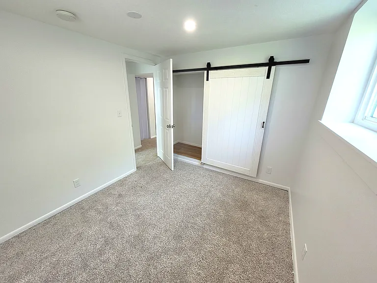 Bedroom 5 with closet and barn door