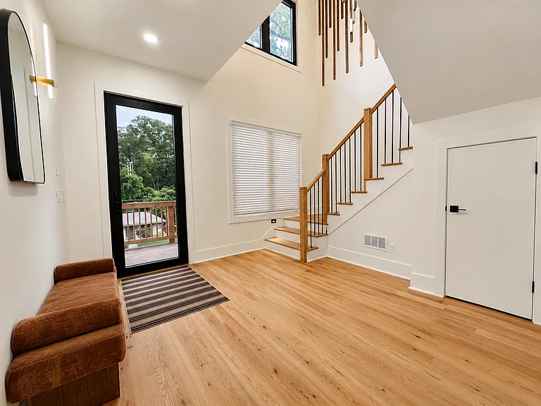 Enjoy a cup of espresso or tea from your custom espresso bar on this lovely front porch and designer seating.