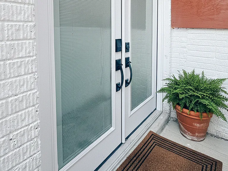Private entrance with French doors, smart lock access, and a clean exterior entryway.