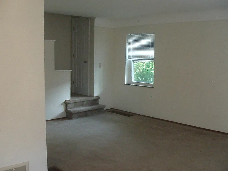 dining room looking into living room, stairwell includes a large closet for and your storage needs