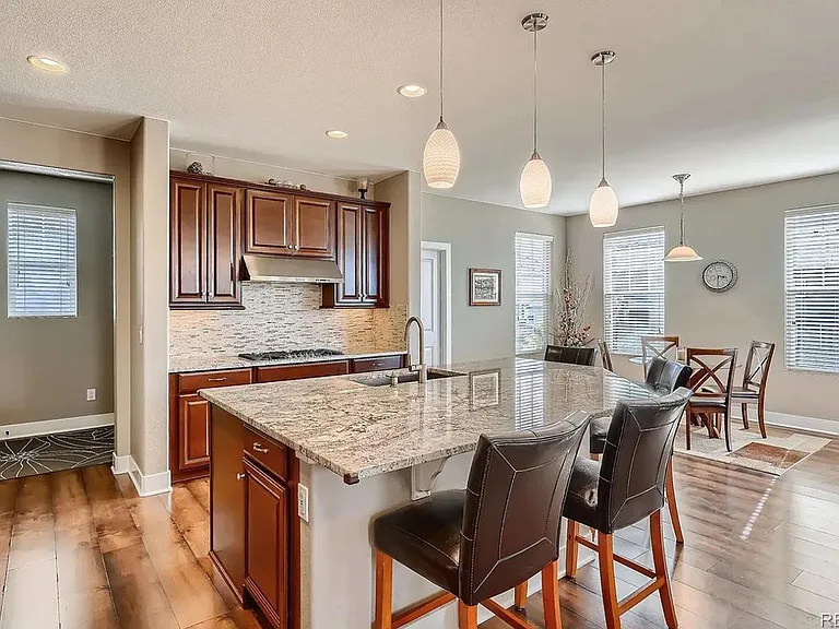 Kitchen connects the mudroom to the dining nook to the family room