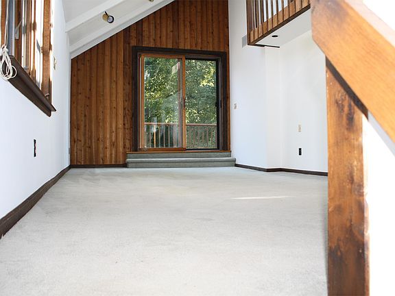 Large family room with slider to outdoor deck. Skylights make room bright.