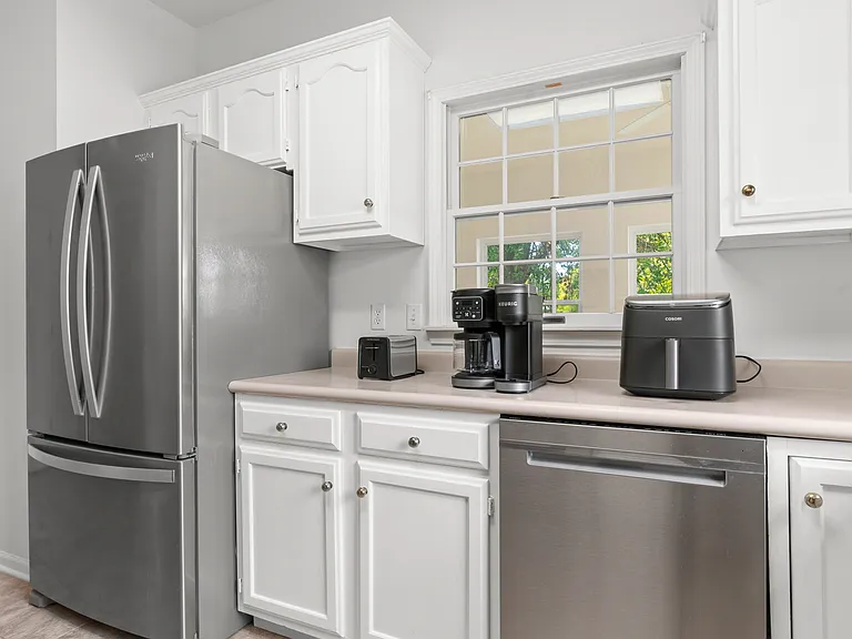 UNDER RENOVATION. to update to Quarts Countertop. - Bright, fully equipped kitchen with generous cabinet space, stainless steel appliances, countertop essentials, and a separate pantry for additional storage.