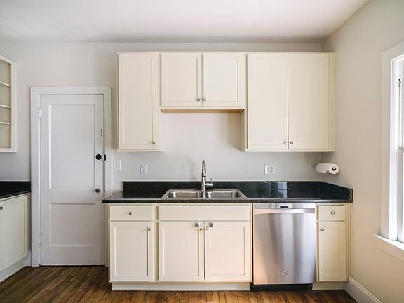 Recently renovated kitchen with new cabinets, dishwasher, refrigerator, stove, microwave and sink.