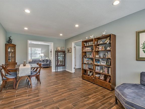 After the entry hall this great room welcomes you with enough space for a formal dining table and sitting area. Plus notice the family room in the back.