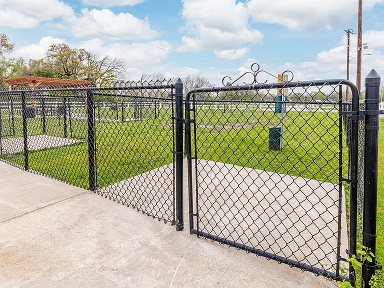 Fenced dog park entrance, providing a secure space for pets to play