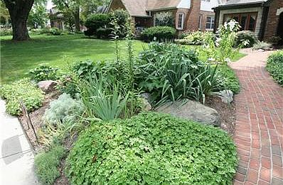 Beautiful front landscaping beds and brick walkway.