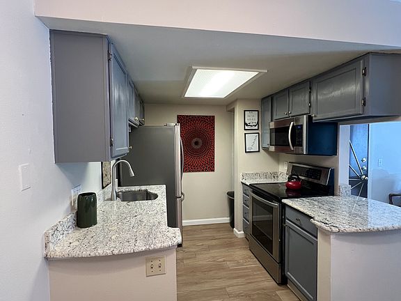 Kitchen with painted cabinets and stainless steel appliances