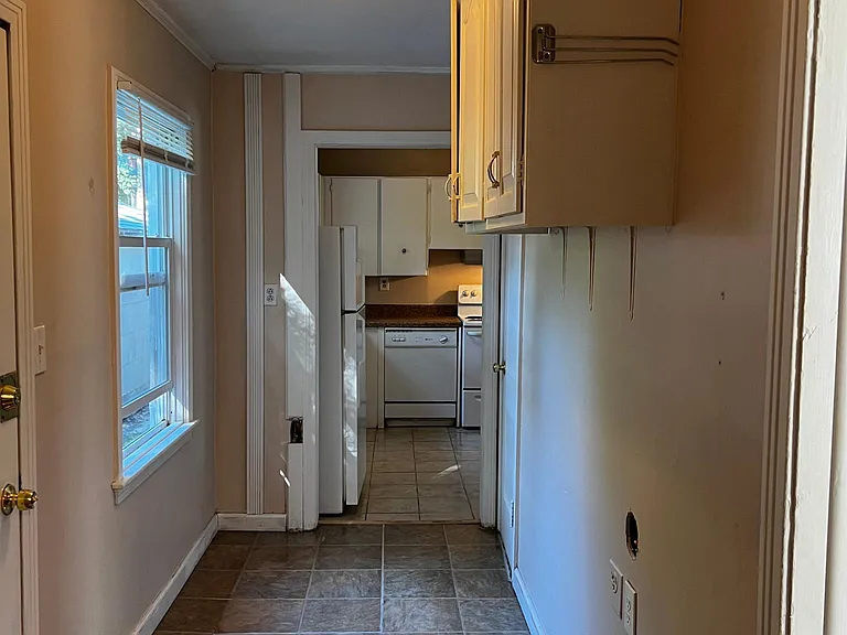 Hallway to kitchen and back bedroom and half bath.