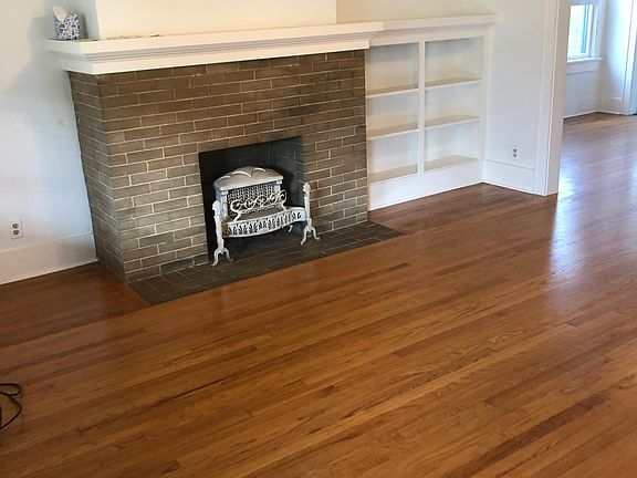 The fireplace is the focal point of the living room with amazing hardwood floors. This room leads to the formal dining room and on to the kitchen in the rear of the house.