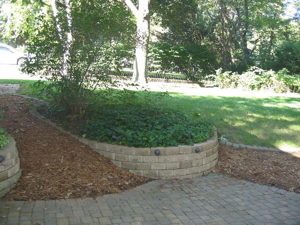 View Backyard looking to left side.  More perennials, stone retaining walls