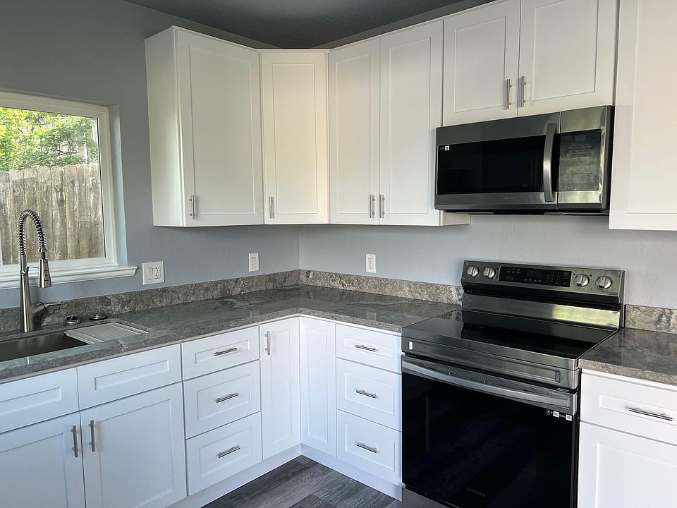 brand new kitchen with quartz countertops and brand new stainless steel appliances
